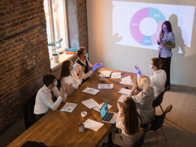 speaker-giving-presentation-meeting-room-scaled.jpg